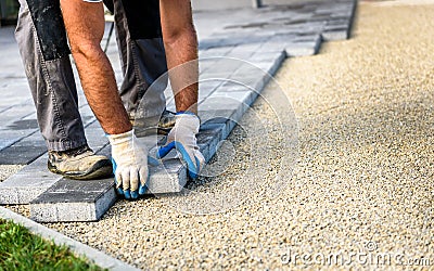 Laying gray concrete paving slabs in house courtyard driveway pa Stock Photo