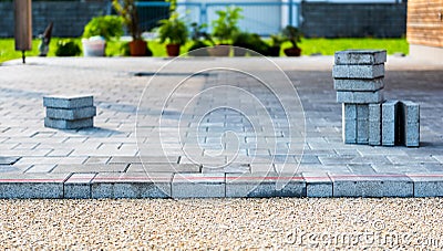 Laying gray concrete paving slabs in house courtyard driveway pa Stock Photo