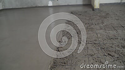 Laying mortar on a concrete floor. Night concrete work on the ground floor leveling the floor Stock Photo