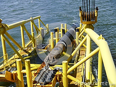 Laying of pipes with pipe-laying barge crane near the shore. Descent of the pipeline to a bottom exhausting with the pipelaying ba Stock Photo