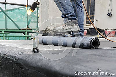 Laying of waterproofing sheathing and insulation on a roof Stock Photo