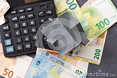 Layout of a house, banknotes , calculator lying on the table. Insurance, credit, mortgage, real estate purchase Stock Photo