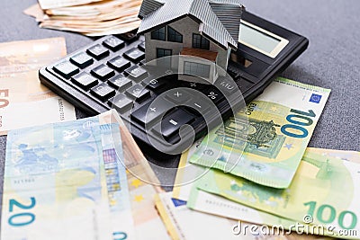 Layout of a house, banknotes , calculator lying on the table. Insurance, credit, mortgage, real estate purchase Stock Photo