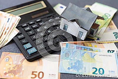 Layout of a house, banknotes , calculator lying on the table. Insurance, credit, mortgage, real estate purchase Stock Photo