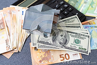 Layout of a house, banknotes , calculator lying on the table. Insurance, credit, mortgage, real estate purchase Stock Photo