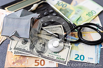 Layout of a house, banknotes , calculator lying on the table. Insurance, credit, mortgage, real estate purchase Stock Photo