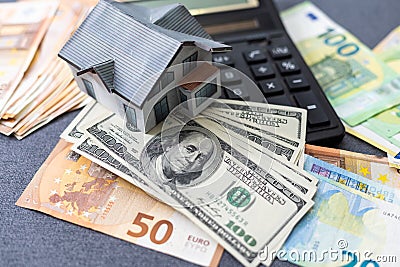 Layout of a house, banknotes , calculator lying on the table. Insurance, credit, mortgage, real estate purchase Stock Photo