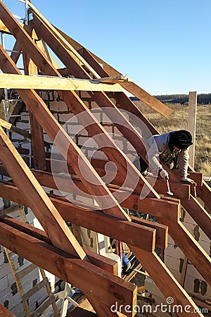 Layout and installation of roof rafters on a new commercial residential construction project by framing contractors Stock Photo