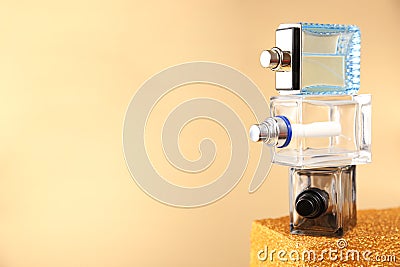 Layout stack of three unbranded perfume bottles on golden podium on gold background. Front view, mockup Stock Photo