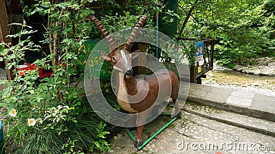 LAZAREVSKOE, SOCHI, RUSSIA - MAY, 29, 2021: Wooden figurine of a goat in the recreation area of Berendeyevo Kingdom Editorial Stock Photo