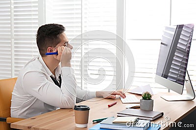 Lazy employee wasting time at table Stock Photo