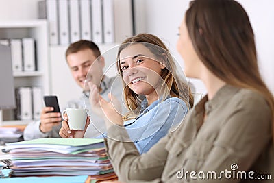 Lazy employees talking and wasting time at office Stock Photo