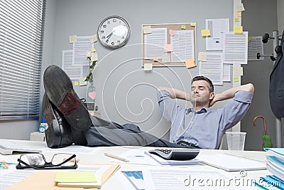 Lazy office worker feet up Stock Photo