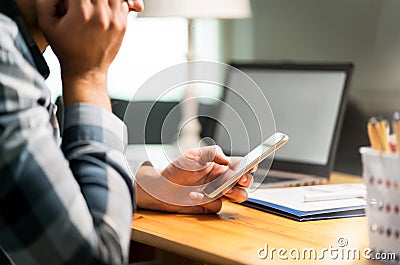 Lazy worker using phone in office avoiding work Stock Photo