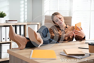 Lazy worker at wooden desk Stock Photo