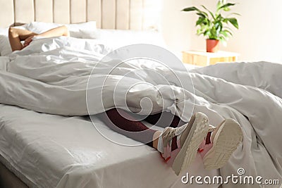 Lazy woman sleeping on bed instead of morning training, closeup Stock Photo