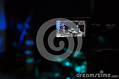 LCD display on the camcorder. Filming of the concert. Musicians playing the double bass and drums Editorial Stock Photo