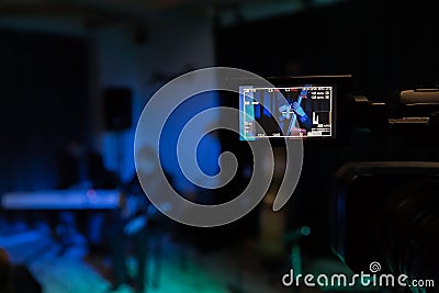 The LCD display on the camcorder. Filming the concert. Musicians playing the double bass, synthesizer and guitar Editorial Stock Photo