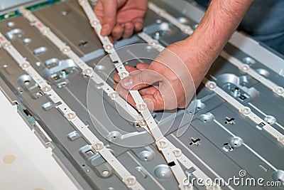 LCD TV repair, disassembly and replacement of LED backlight Stock Photo