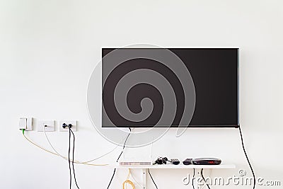 Lcd tv on wall with remote, wireless internet access point and s Stock Photo