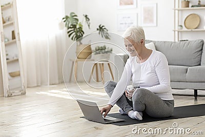 Lderly Woman Choosing Online Tutorials On Laptop For Training At Home Stock Photo