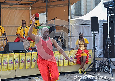 LE MANS, FRANCE - APRIL 22, 2017: Festival Europe jazz A man dances a Caribbean dance. Musicians dress with costumes and playing d Editorial Stock Photo