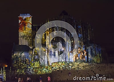 LE MANS, FRANCE - AUGUST 28, 2016: Night of chimera Illuminated perfomance on the wall of Roman and gothic cathedral Editorial Stock Photo