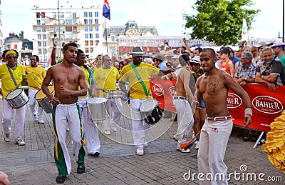 LE MANS, FRANCE - JUNE 13, 2014: Brazilian man dancing at a parade of pilots racing. Editorial Stock Photo