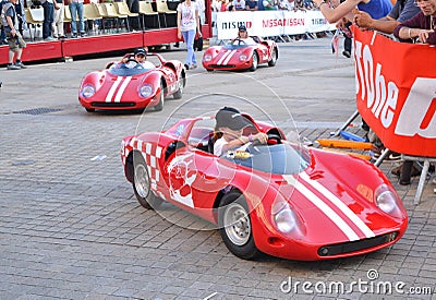 LE MANS, FRANCE - JUNE 13, 2014: Childrens on sports cars on Parade of pilots racing Editorial Stock Photo