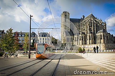 LE MANS, FRANCE - OCTOBER 08, 2017: Roman cathedral of Saint Julien with an orange tram at a Le mans, France Editorial Stock Photo