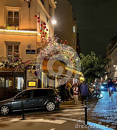 Le Vrai Paris restaurant awning decorated with pink and white sprays of flowers, October 2021, Paris, France Editorial Stock Photo