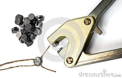 Lead sealing press with a lead seal and twine. Stock Photo