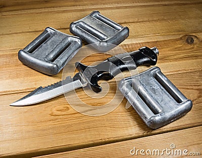 Lead weights and a diver's knife Stock Photo