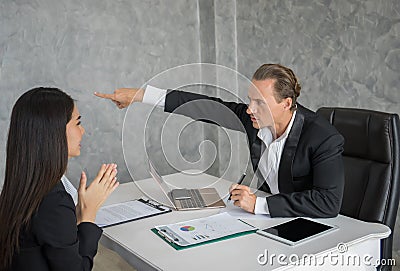 Leader businessman blaming female employee at office desk. Fail business Stock Photo