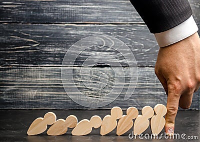 Leader businessman stops falling dominoes. Strong and reliable boss. Difficulties in business and their solution. Support team. Th Stock Photo