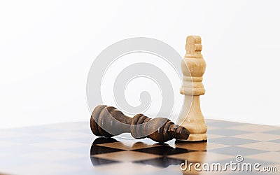 Leader and competition. White Chess King among lying down black pawns on chessboard Stock Photo