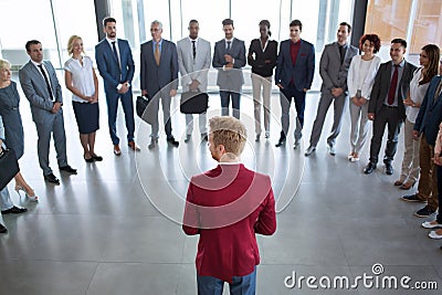 Leader standing in front of his successful business team Stock Photo