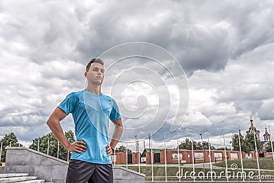 Leader strong male athlete, stands city in summer, controls training. Fitness workout coach, active lifestyle modern Stock Photo