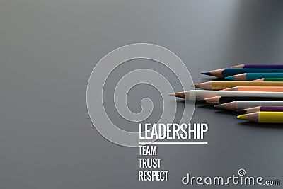 Leadership business concept. Gold color pencil lead other color with word Leadership, team, trust and respect on black background Stock Photo