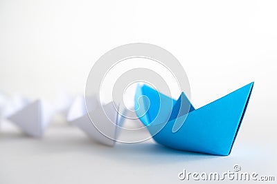 Leadership concept. blue paper ship lead among white. Stock Photo