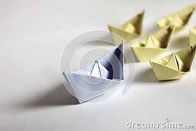 Leadership concept. Paper boats on a white background. Stock Photo