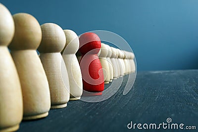 Leadership development. Line of wooden figurines with red one Stock Photo