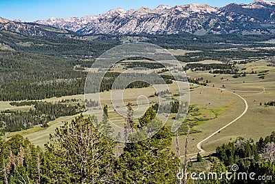 Beautiful valley view of the Frank Church Wilderness in central Idaho. Winding dirt road leads to the mountains Stock Photo