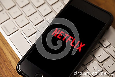 Leading platform in the movie streaming segment, netflix with the application open on a cell phone. Editorial Stock Photo