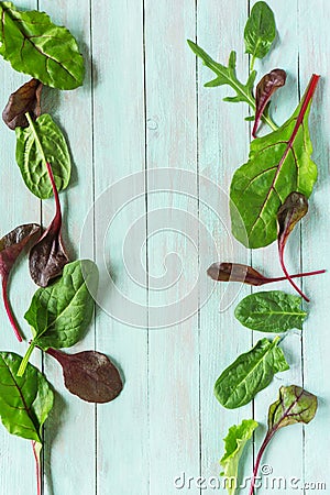 Leafy vegetables, spinach and rukola on a wooden background Stock Photo