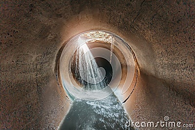 Leak of water into round sewer tunnel Stock Photo