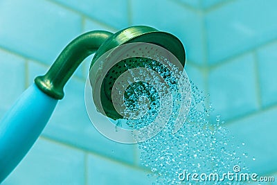 Leaking old shower on a blue background Stock Photo