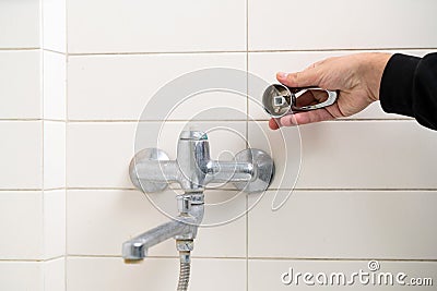 Leaking shower faucet. Broken bathtub handle. Emergency repair Stock Photo