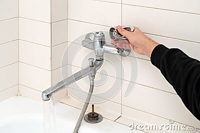 Leaking shower faucet. Broken bathtub handle. Emergency repair Stock Photo