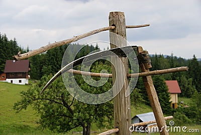 Leaning scythe Stock Photo